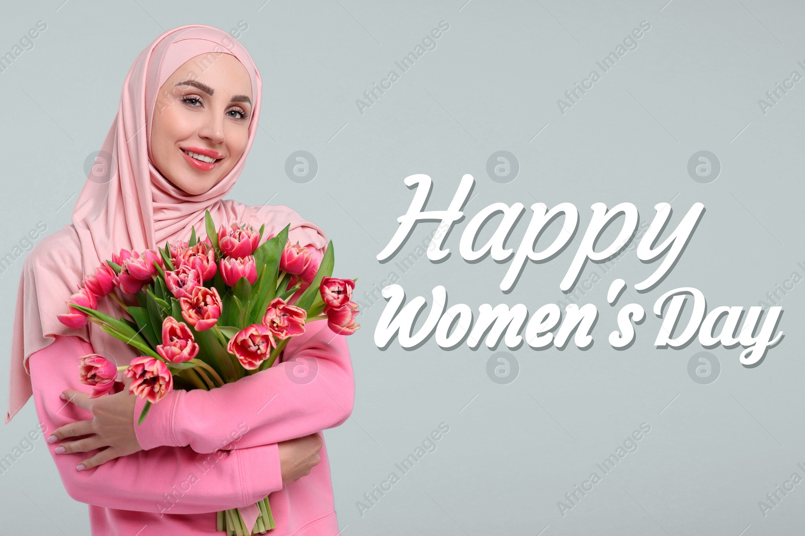 Image of Happy Women's Day - March 8. Attractive lady in hijab with bouquet of tulips on light grey background