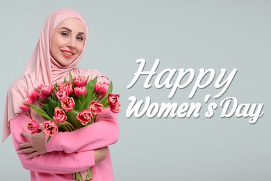 Happy Women's Day - March 8. Attractive lady in hijab with bouquet of tulips on light grey background