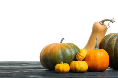 Photo of Happy Thanksgiving day. Different pumpkins on black wooden table against white background. Space for text