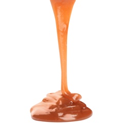 Photo of Pouring sweet caramel sauce on white background