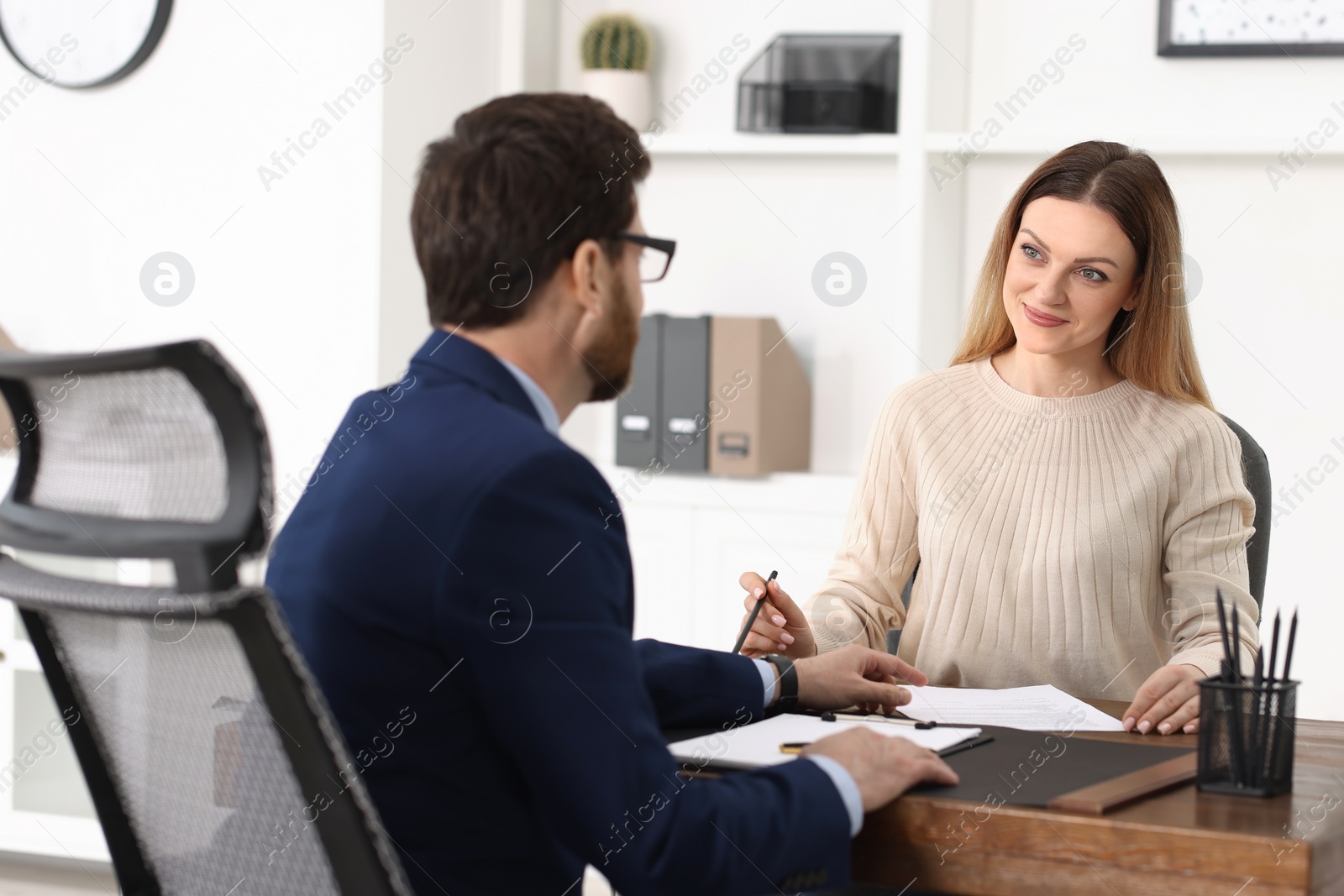 Photo of Woman having meeting with lawyer in office, selective focus