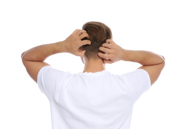 Photo of Young man scratching head on white background. Annoying itch