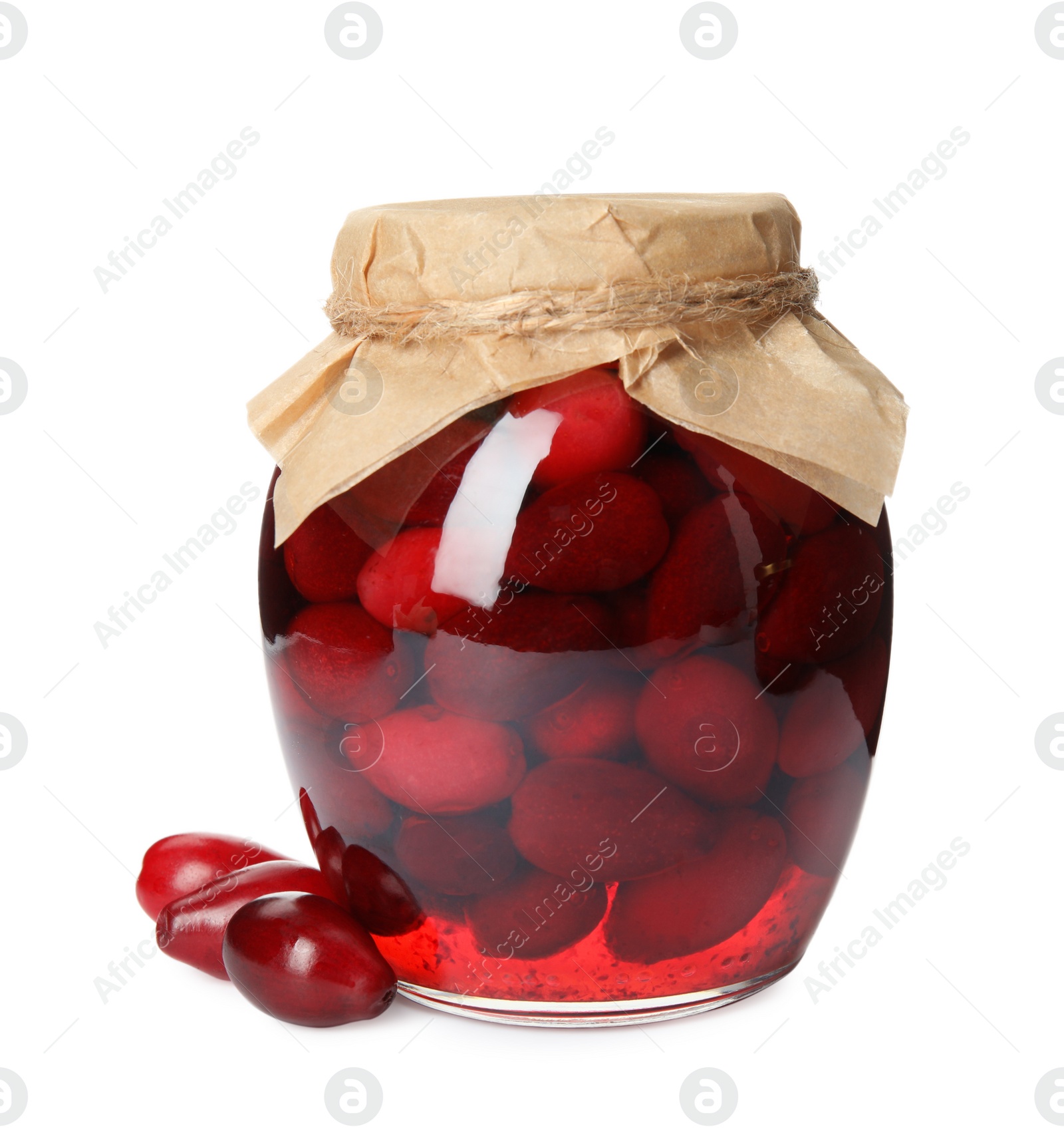 Photo of Delicious dogwood jam with berries on white background