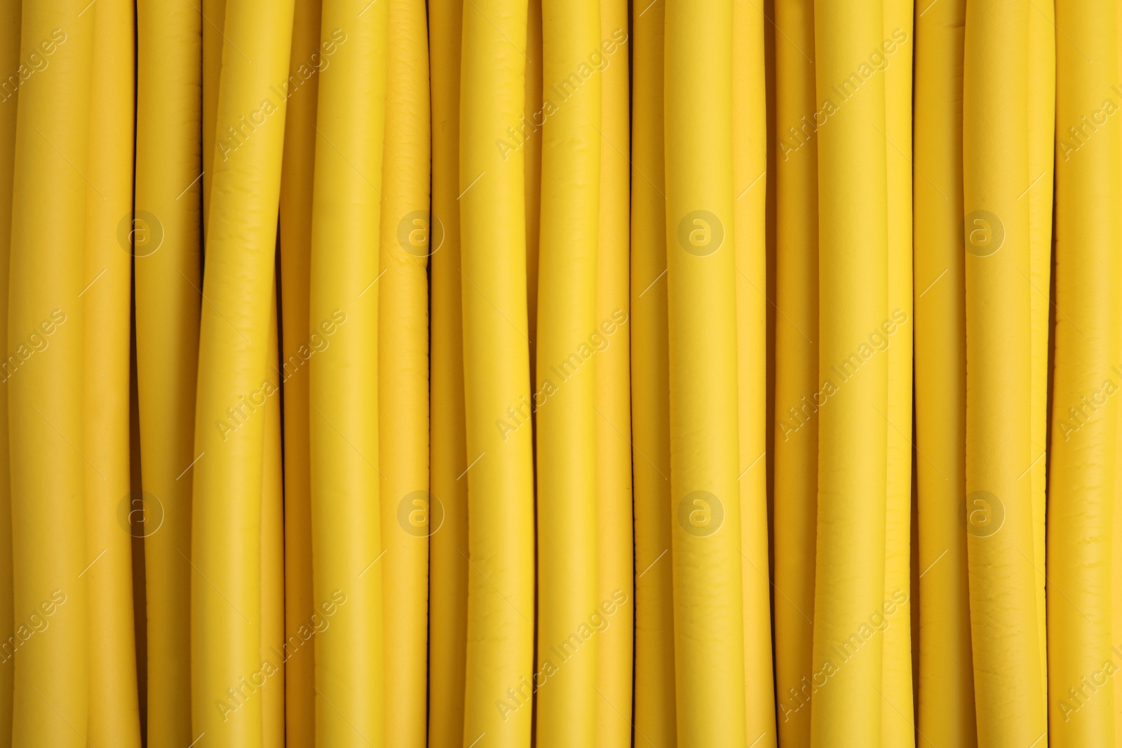 Photo of Curling rods as background, closeup. Hair styling tool