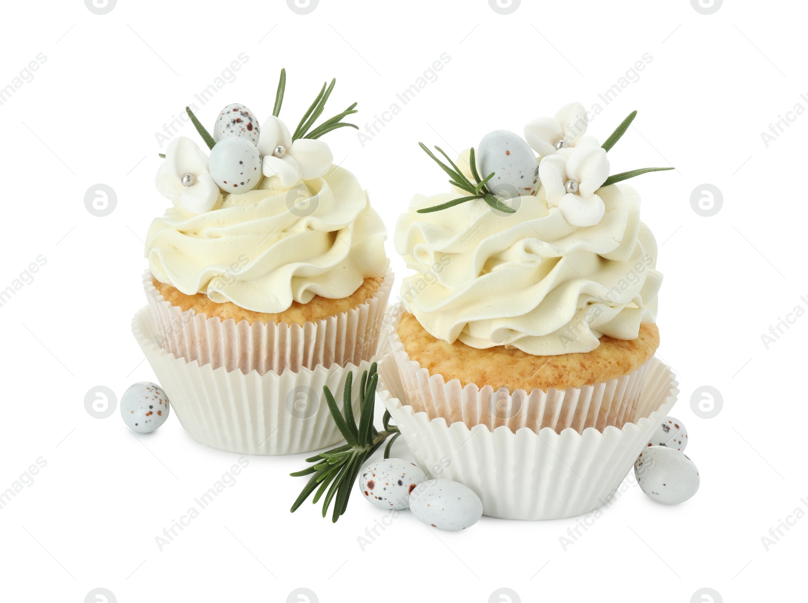 Photo of Tasty Easter cupcakes with vanilla cream, candies and rosemary isolated on white