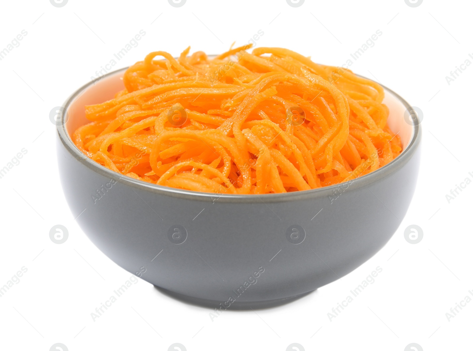 Photo of Delicious Korean carrot salad in bowl isolated on white