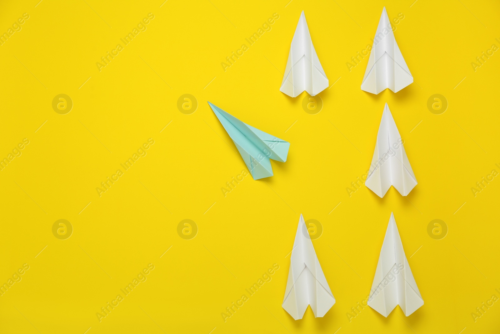 Photo of Different handmade paper planes on yellow background. Space for text