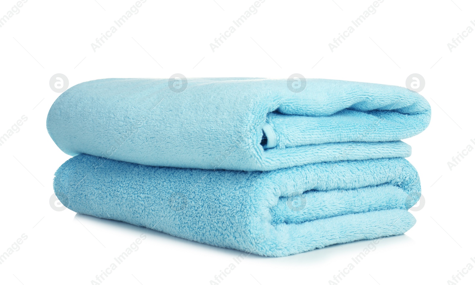 Photo of Folded soft terry towels on white background