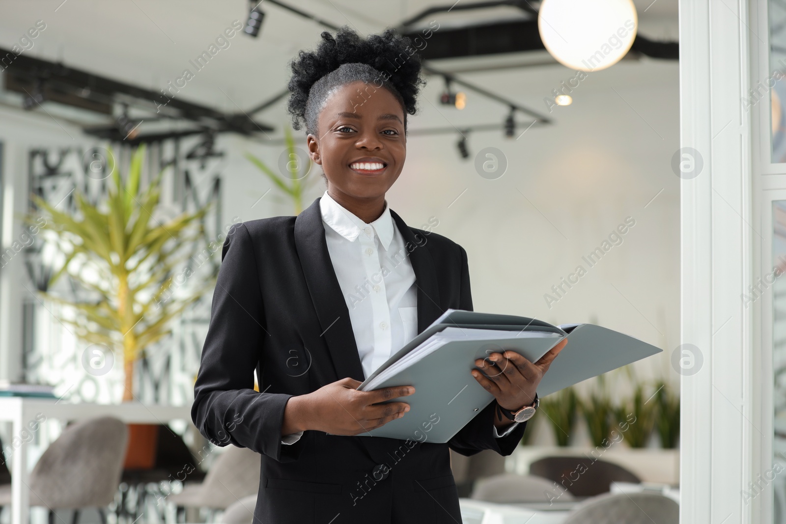 Photo of Happy woman with folders in office. Lawyer, businesswoman, accountant or manager