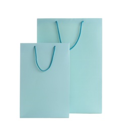 Photo of Light blue paper shopping bags isolated on white