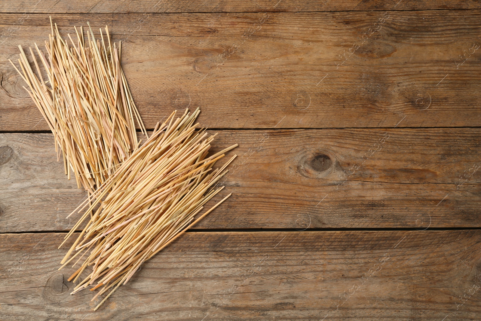 Photo of Dried hay on wooden background, flat lay. Space for text