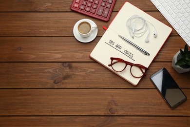 Photo of Flat lay composition with notebook on wooden table, space for text. Tips and Tricks