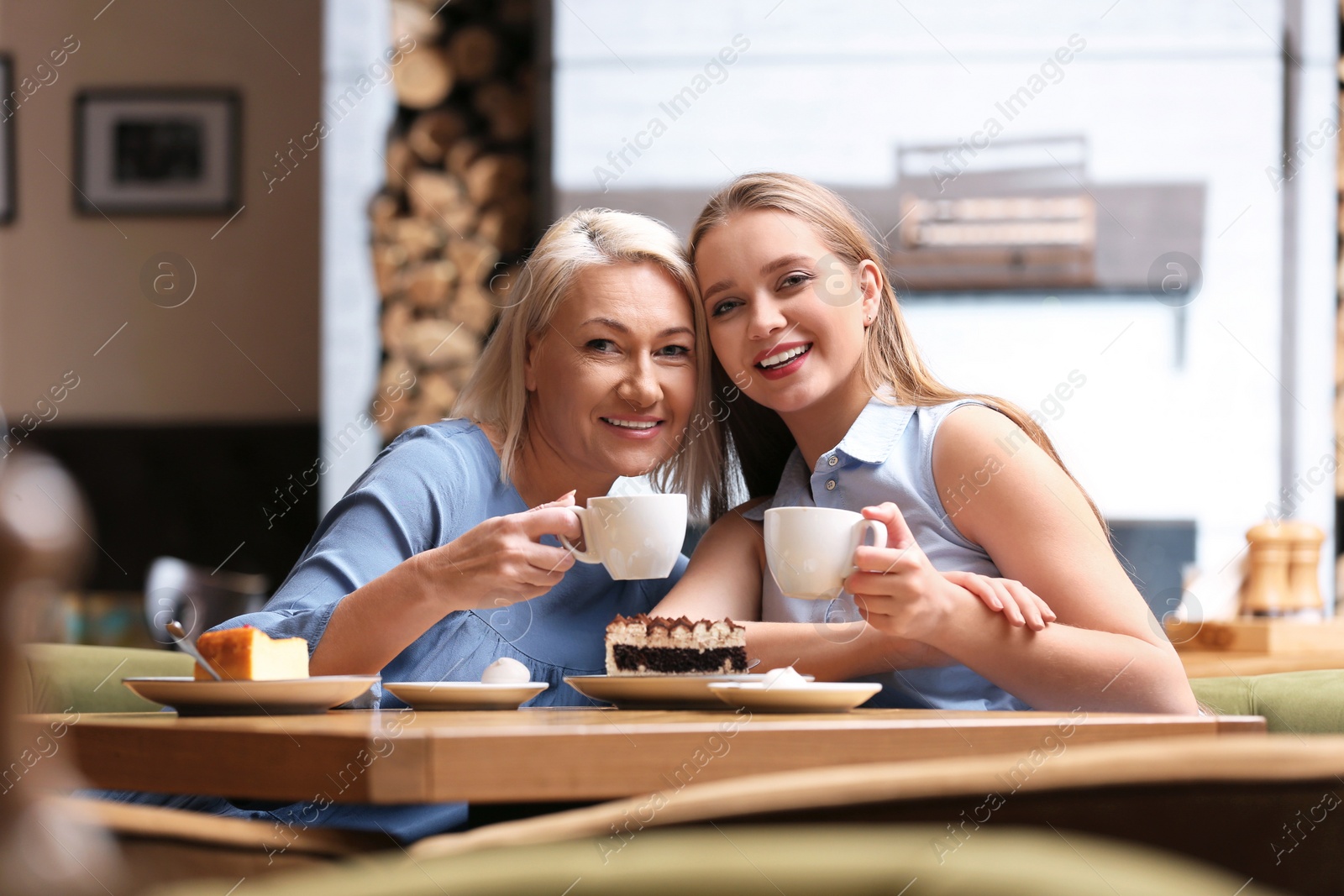 Photo of Mother and her adult daughter spending time together in cafe