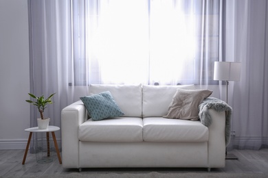 Photo of Modern living room interior with comfortable sofa. Space for text