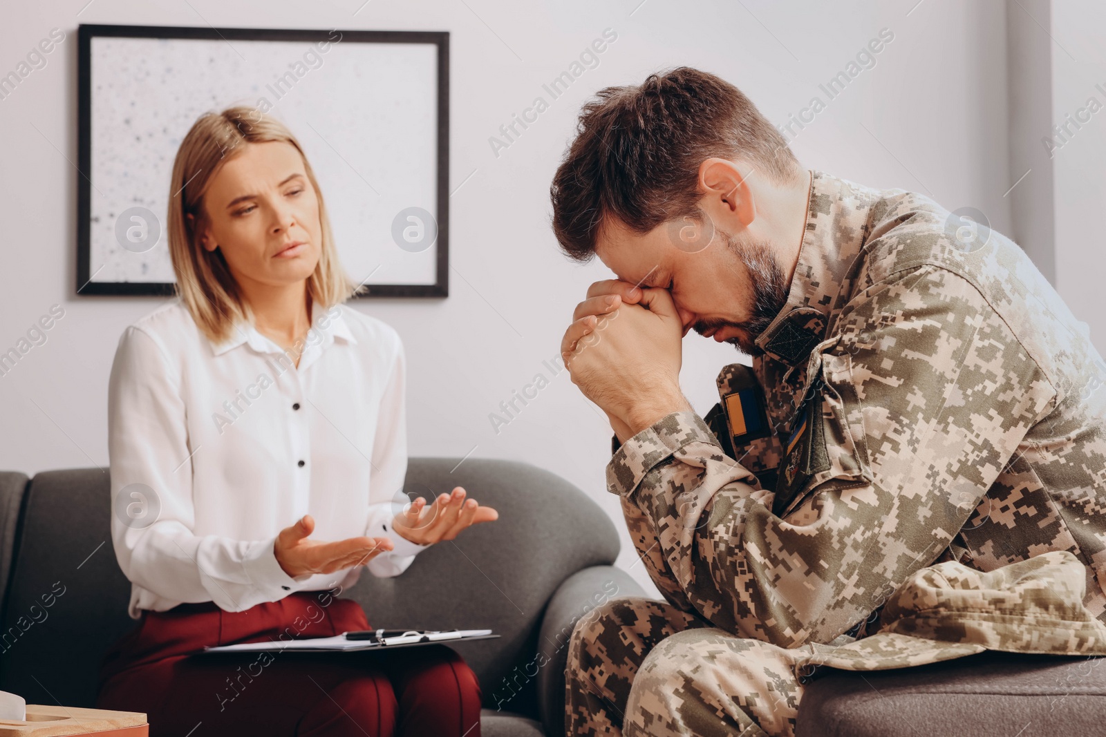 Photo of Psychologist working with military officer in office