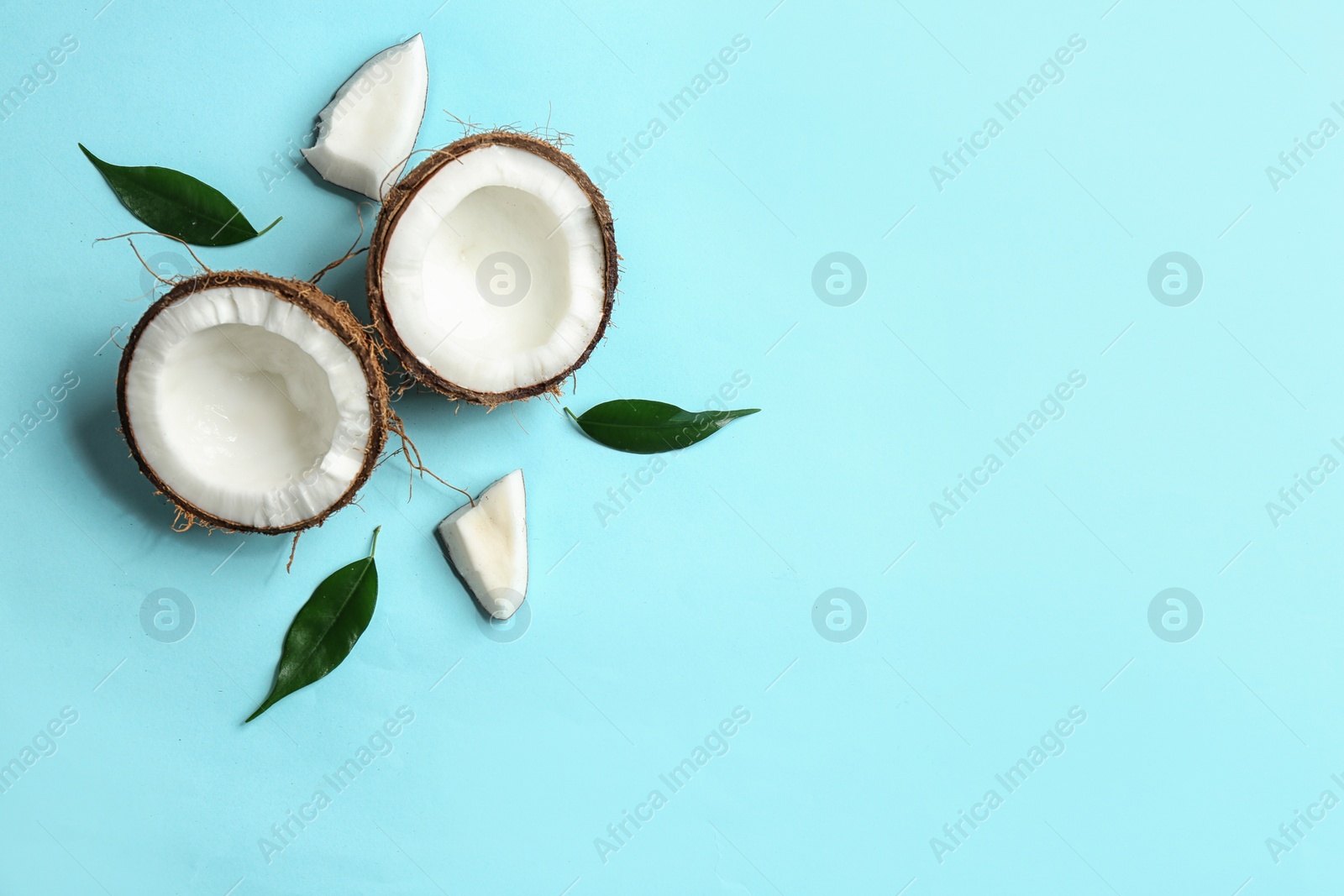 Photo of Flat lay composition with coconuts on color background. Space for text