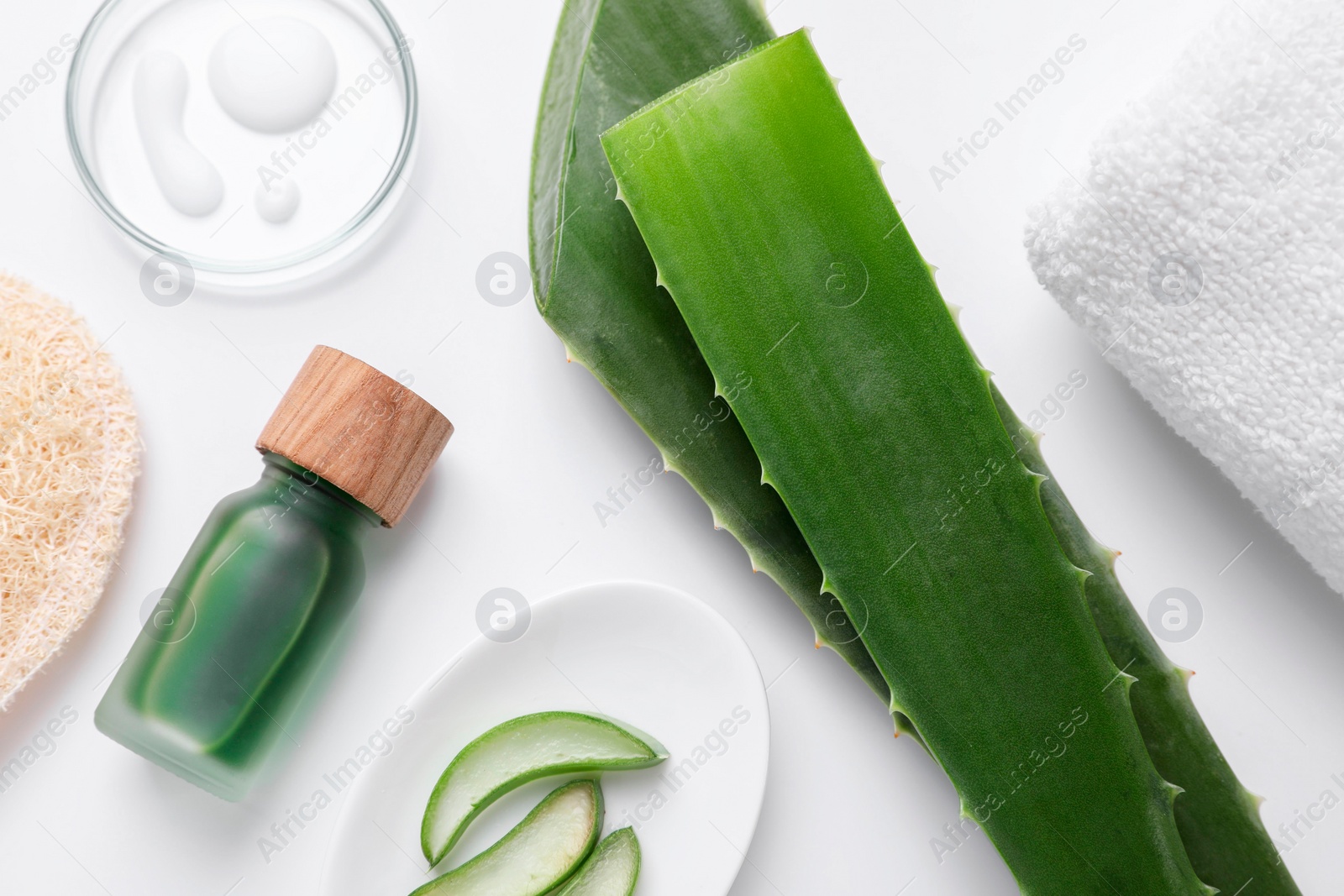 Photo of Flat lay composition with cosmetic products and cut aloe leaves on white background