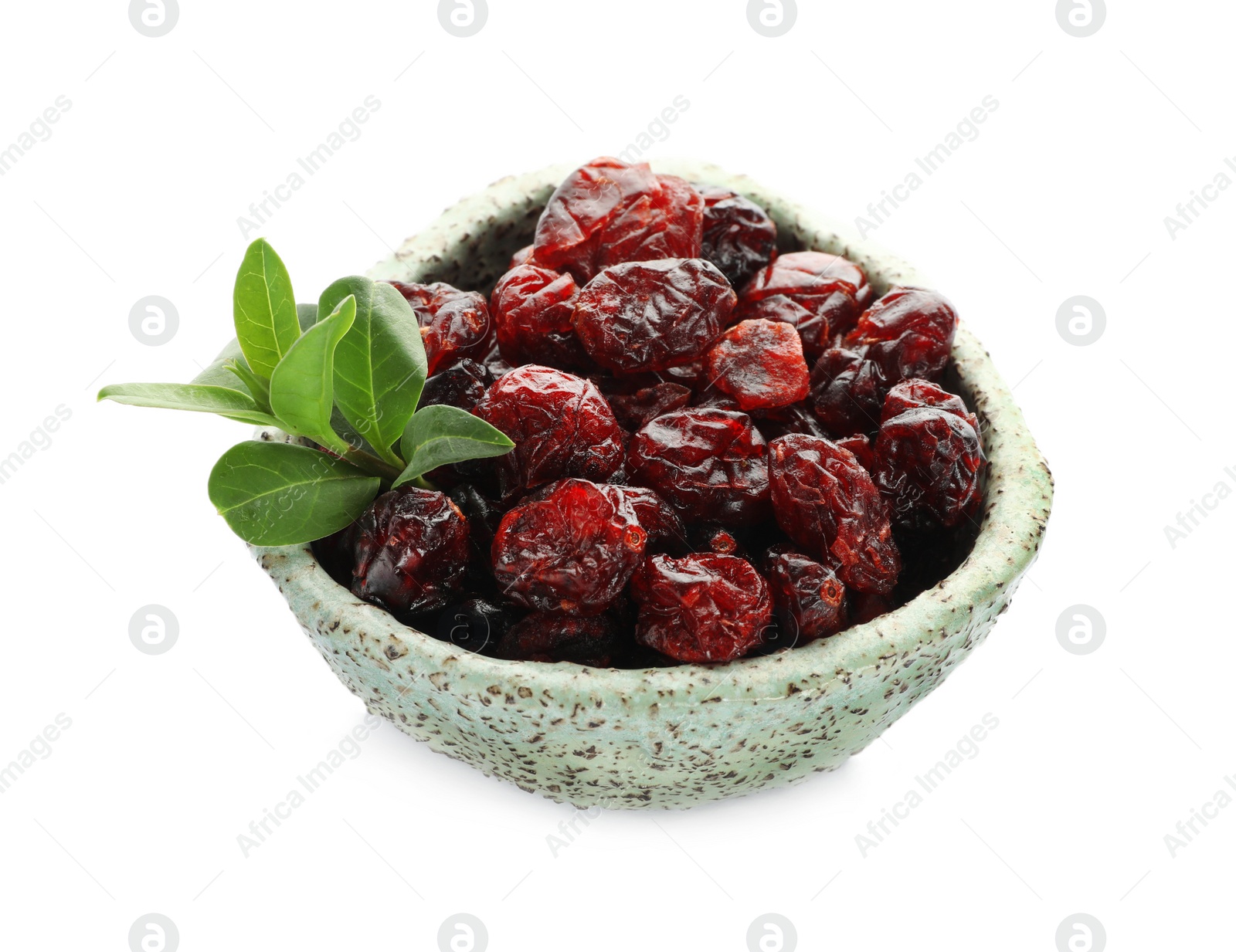 Photo of Tasty dried cranberries and leaves in bowl isolated on white