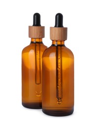 Photo of Bottles of essential oil on white background