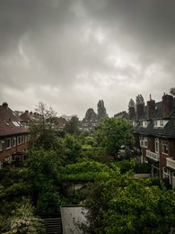 Picturesque view of city street with beautiful buildings on rainy day