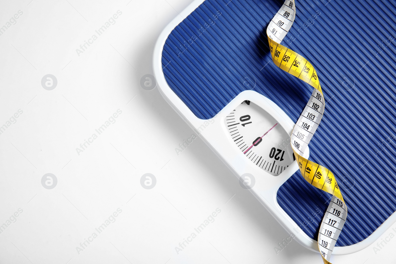 Photo of Modern scales and tape measure on white background, top view