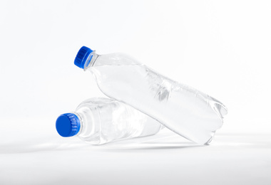 Photo of Plastic bottles with pure water on white background