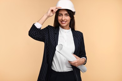 Photo of Architect in hard hat with draft on beige background