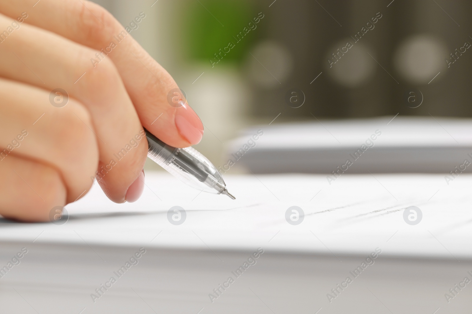 Photo of Woman signing document, closeup view. Space for text