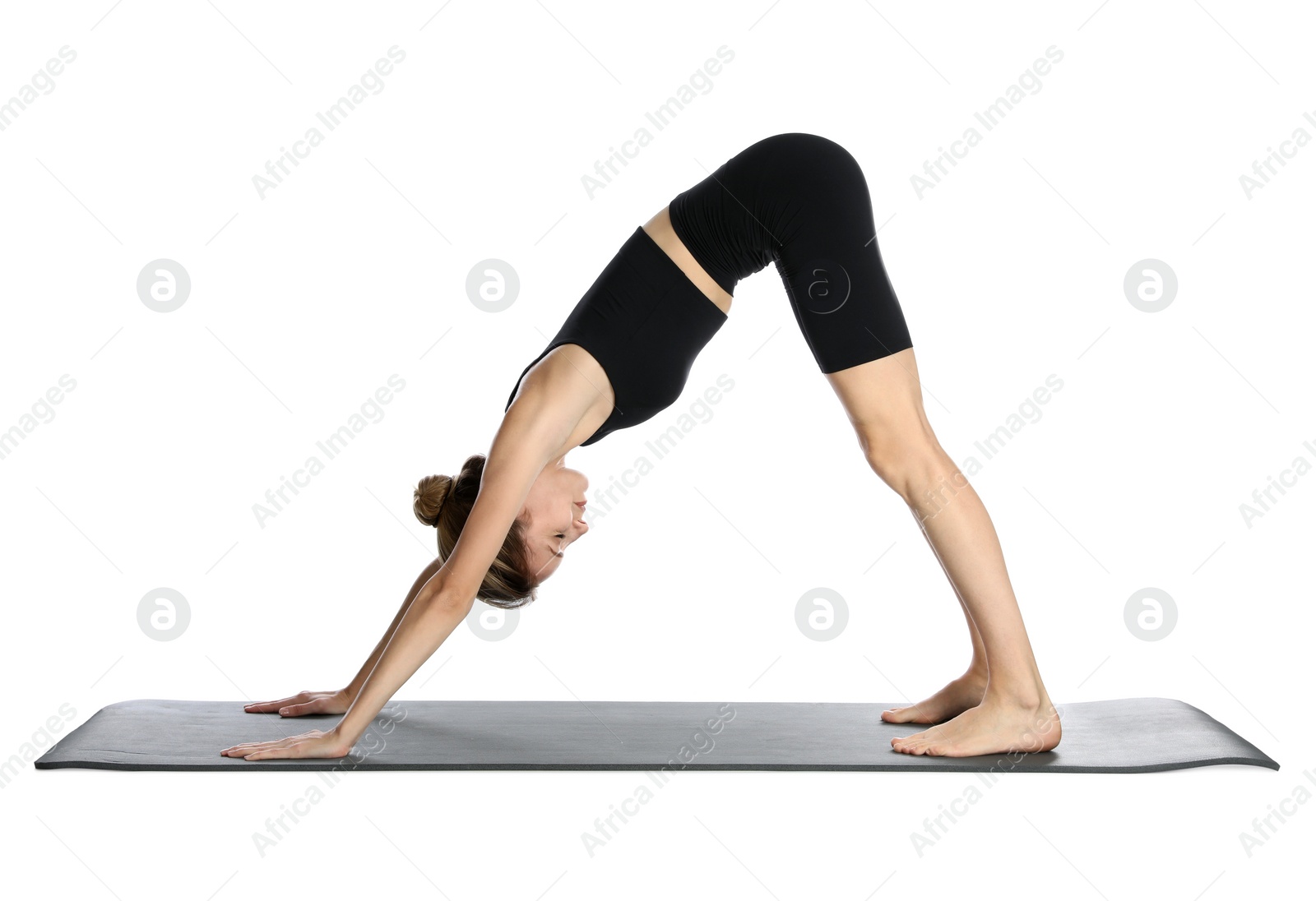 Photo of Young woman in sportswear practicing yoga on white background