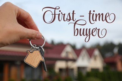 Image of First-time buyer. Woman holding house keys outdoors, closeup