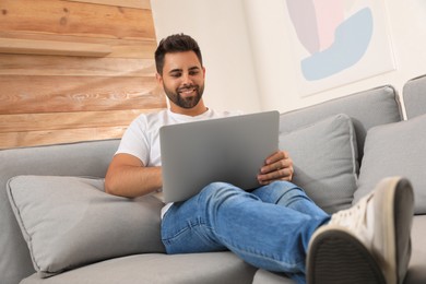 Man using laptop for online shopping at home