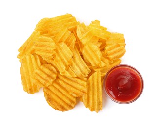 Photo of Delicious ridged chips with ketchup on white background, top view