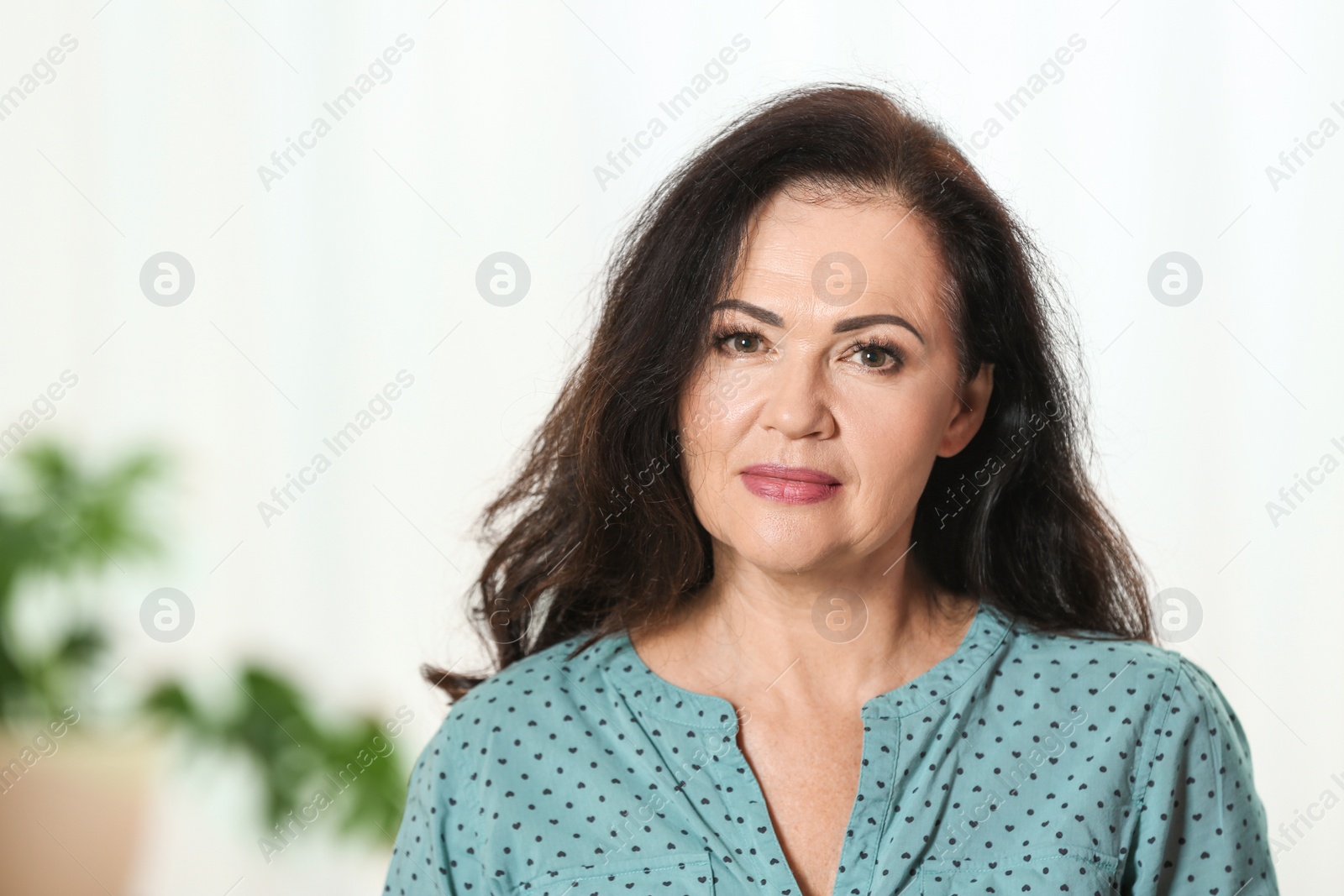 Photo of Portrait of beautiful older woman against blurred background