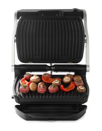 Photo of Electric grill with meat balls, bell pepper and mushrooms isolated on white