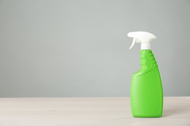 Photo of Bottle of cleaning product on light table. Space for text