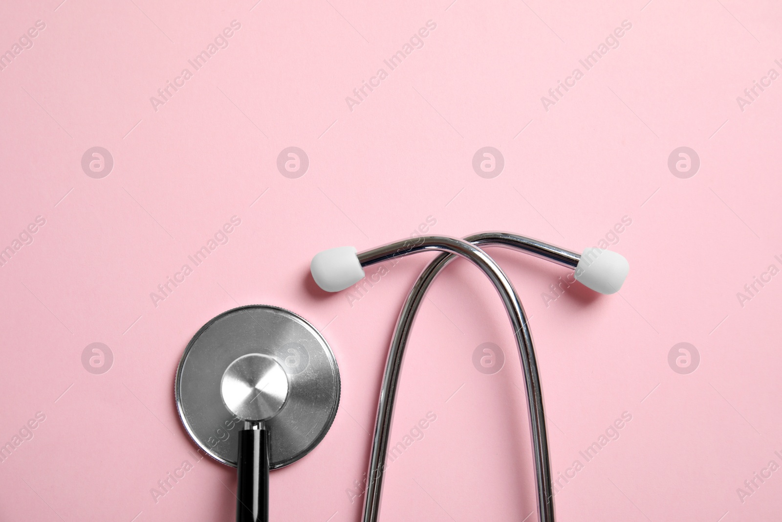 Photo of Stethoscope with space for text on color background, top view. Medical tool