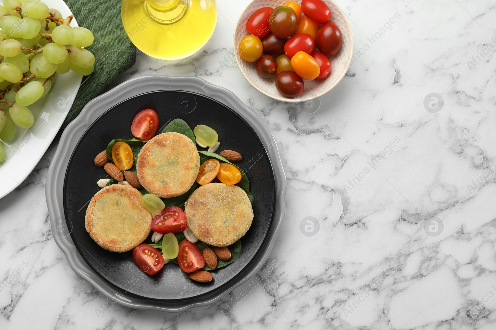 Photo of Plate with healthy dish high in vegetable fats on white marble table, flat lay. Space for text