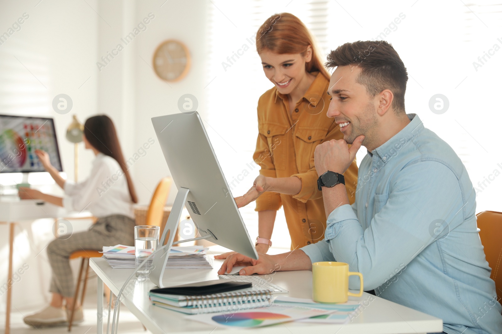 Photo of Professional designers working together in modern office