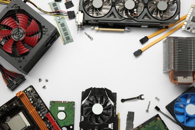 Photo of Frame of graphics card and other computer hardware on white background, flat lay. Space for text