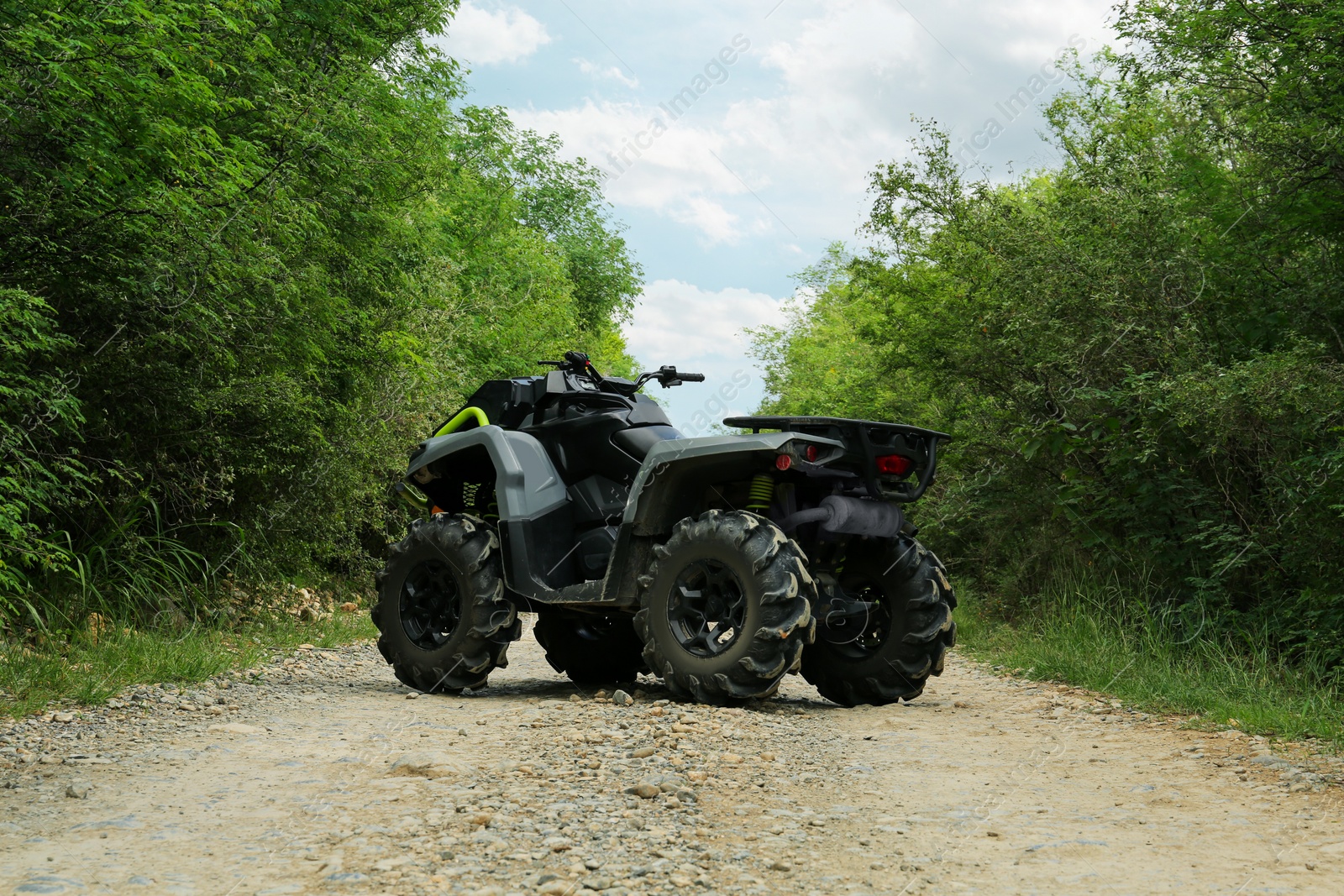 Photo of Beautiful quad bike on pathway near trees outdoors