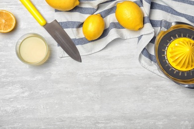 Flat lay composition with lemon juice and space for text on table