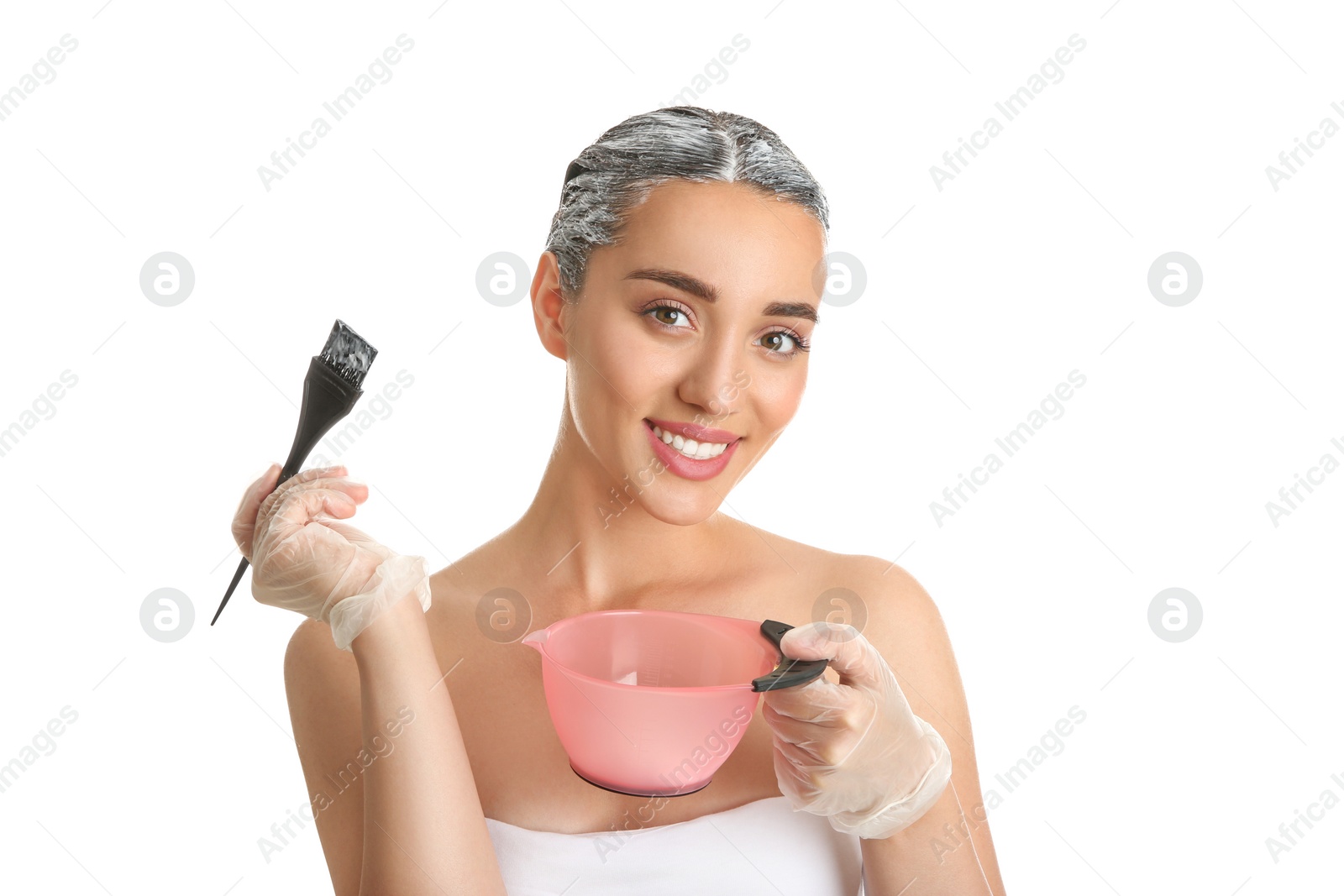 Photo of Young woman dyeing her hair against white background