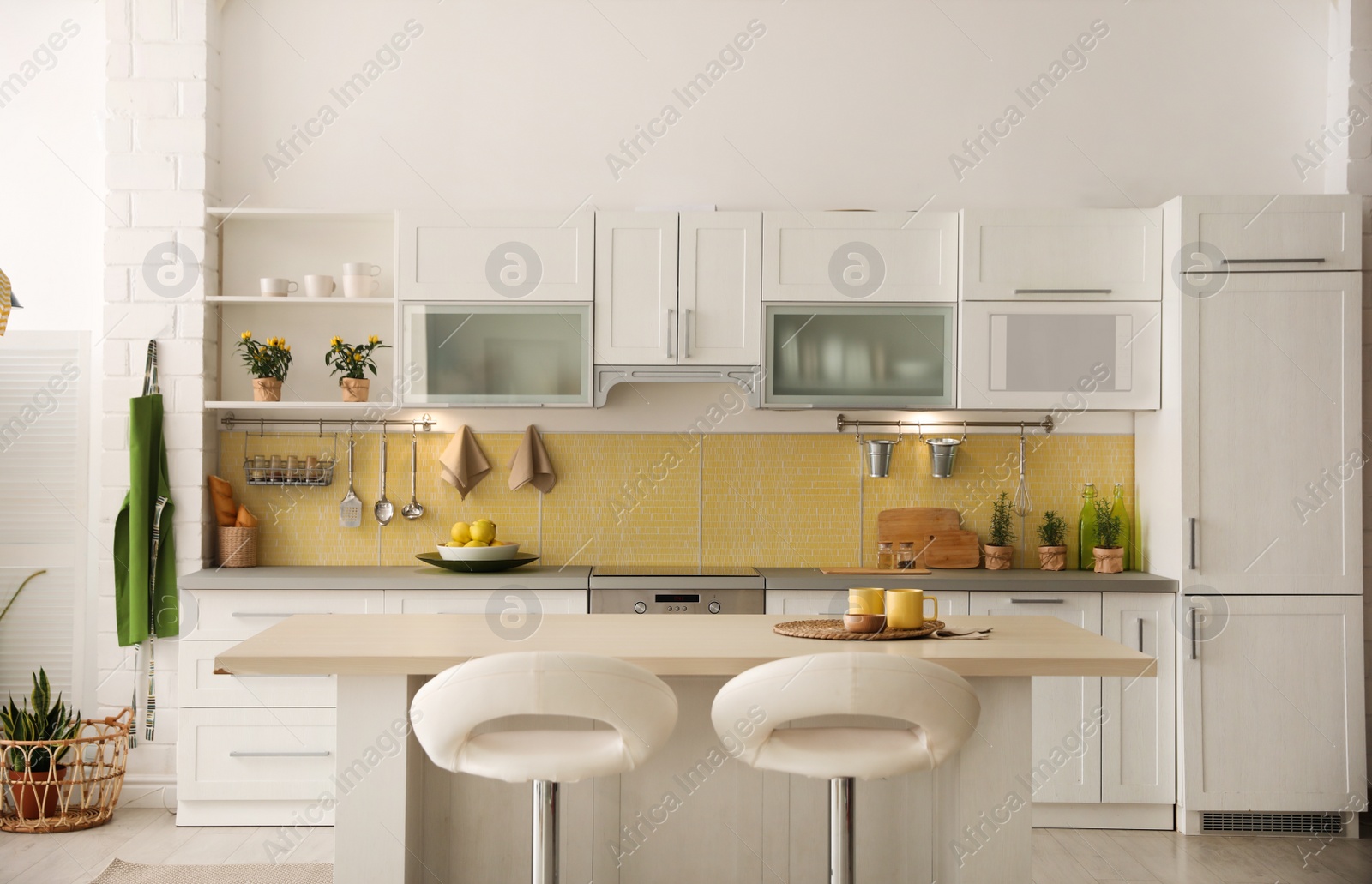 Photo of Modern kitchen interior with stylish white furniture