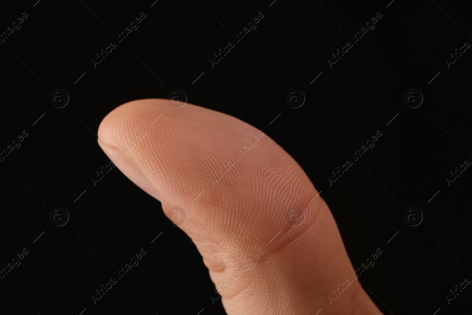 Photo of Man scanning fingerprint on black background, closeup