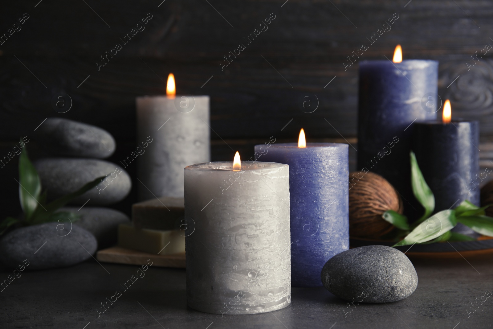 Photo of Spa composition with burning candles on table