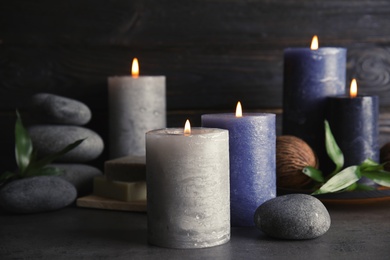 Spa composition with burning candles on table