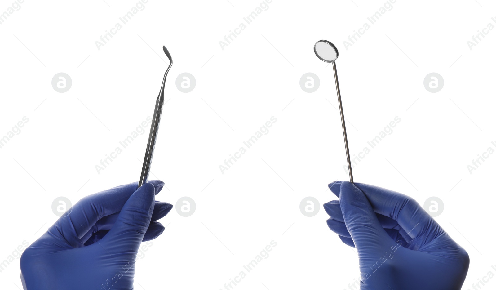 Photo of Dentist holding mouth mirror and plugger on white background, closeup