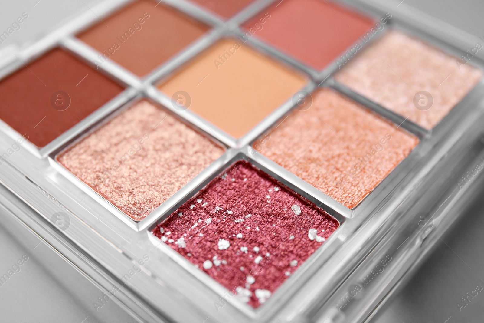 Photo of Beautiful eyeshadow palette as background, closeup. Professional cosmetic product