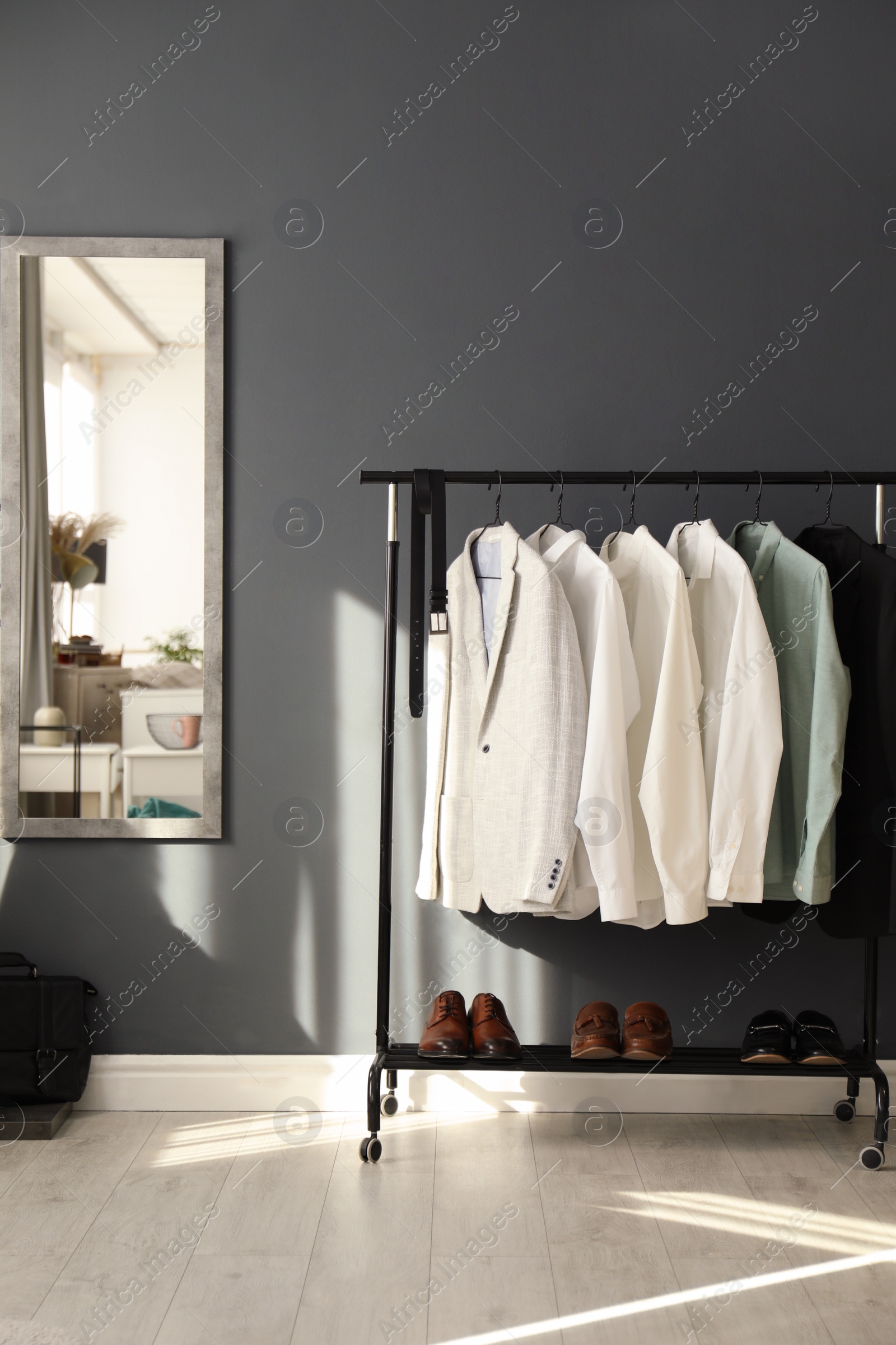 Photo of Dressing room interior with clothing rack and mirror