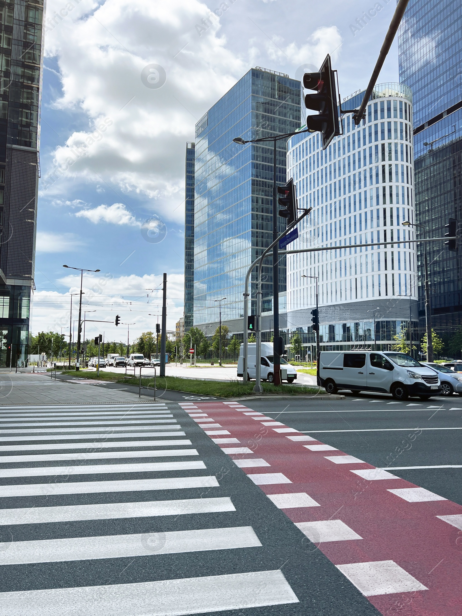 Photo of City street with road, pedestrian crossing, bicycle lane and beautiful buildings